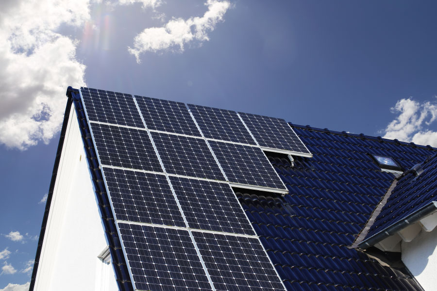 Photo of a home with solar panes installed on the roof.