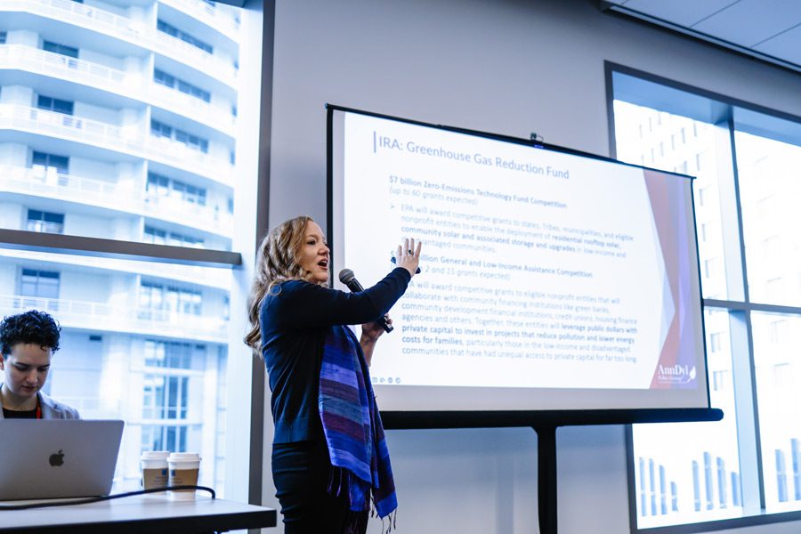 Image of a woman giving a presentation on the Greenhouse Gas reduction fund