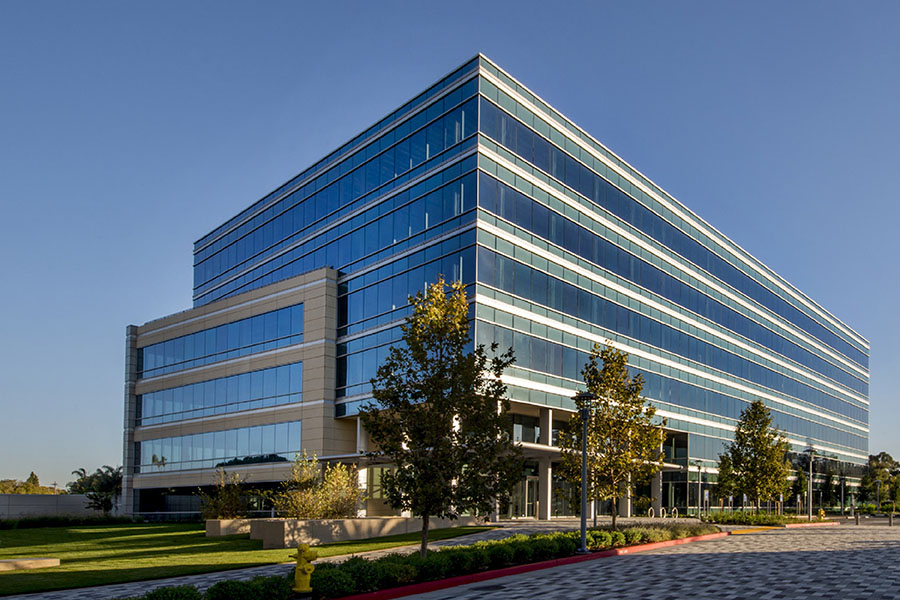 Modern office building with the sunlight reflecting off the window panels