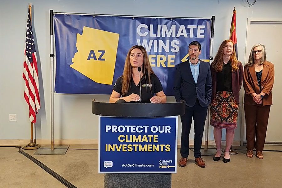 Photo of a woman speaking at a podium on protecting climate investments in Arizone