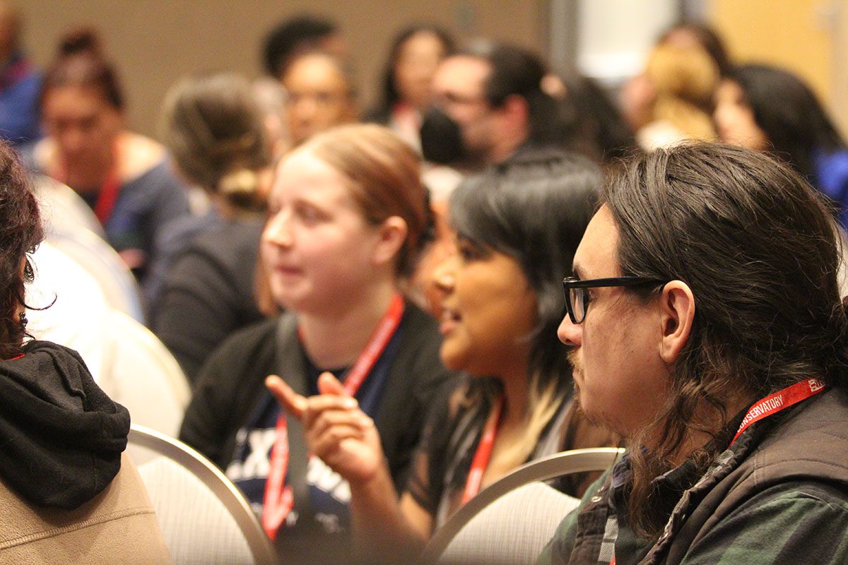 Image of a crowd listening to a presentation