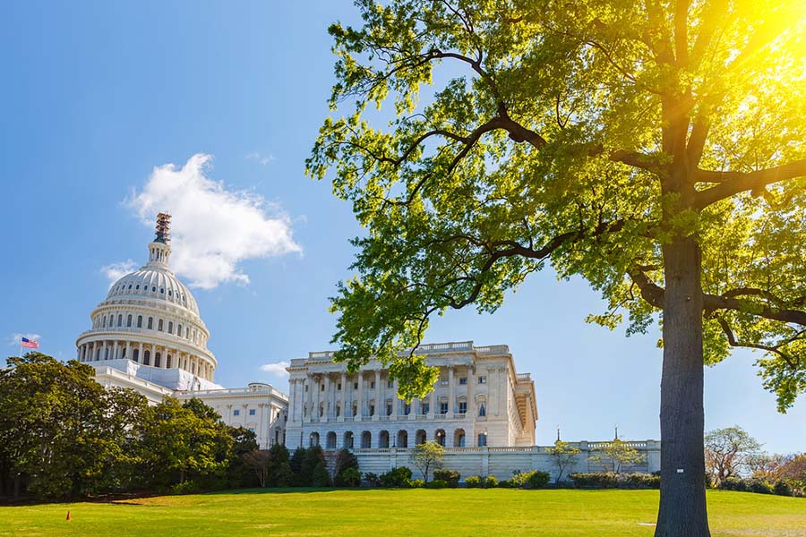 Photo of a capitol building with the sun shining brightly