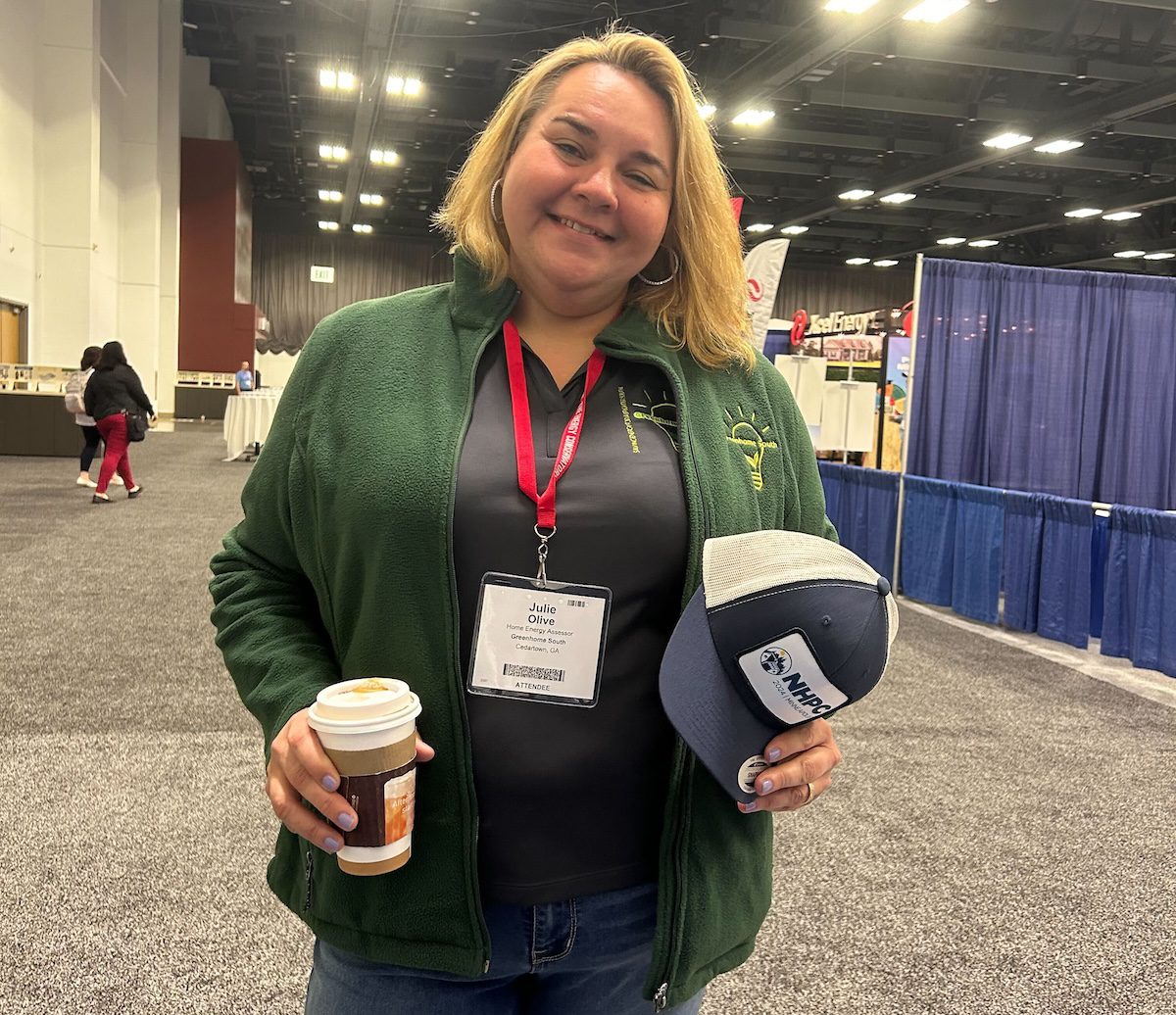 Image of Julie Olive holding a hat and coffee