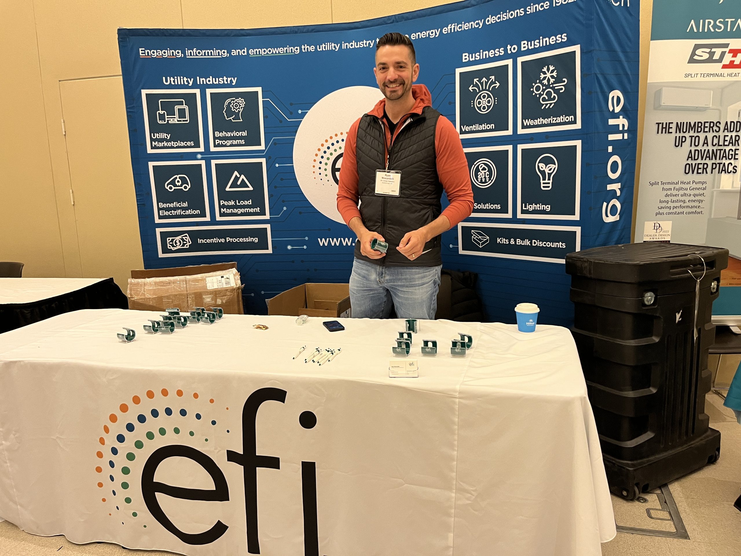 Image of a man at a booth labeled EFI