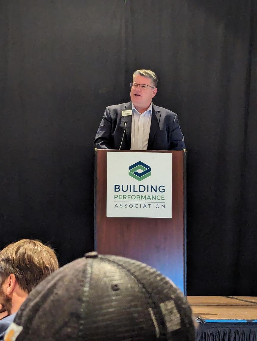 Image of a man presenting at a podium with the BPA logo