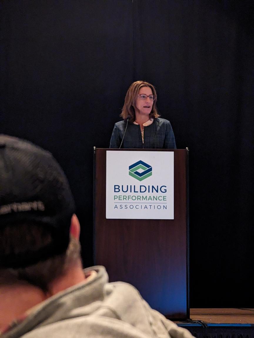 Image of a woman presenting at a podium with the BPA logo