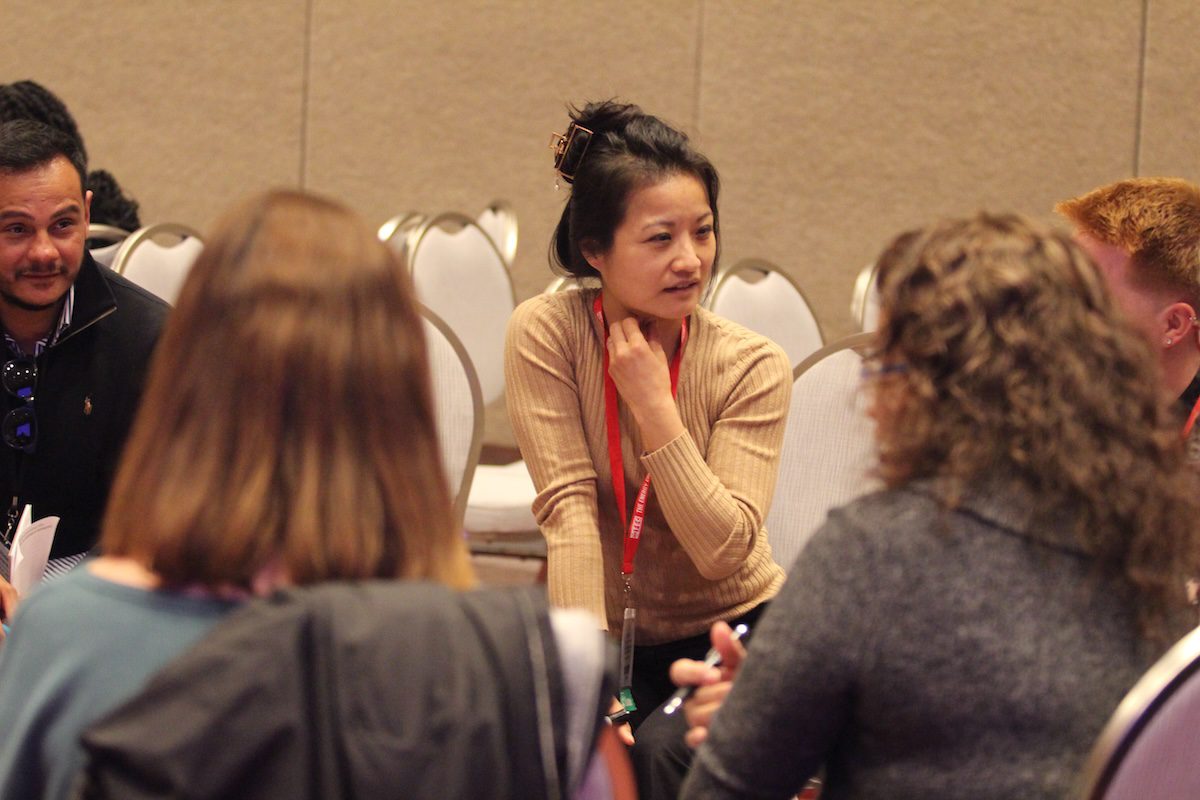 Image of a woman listening to a group share in a circle