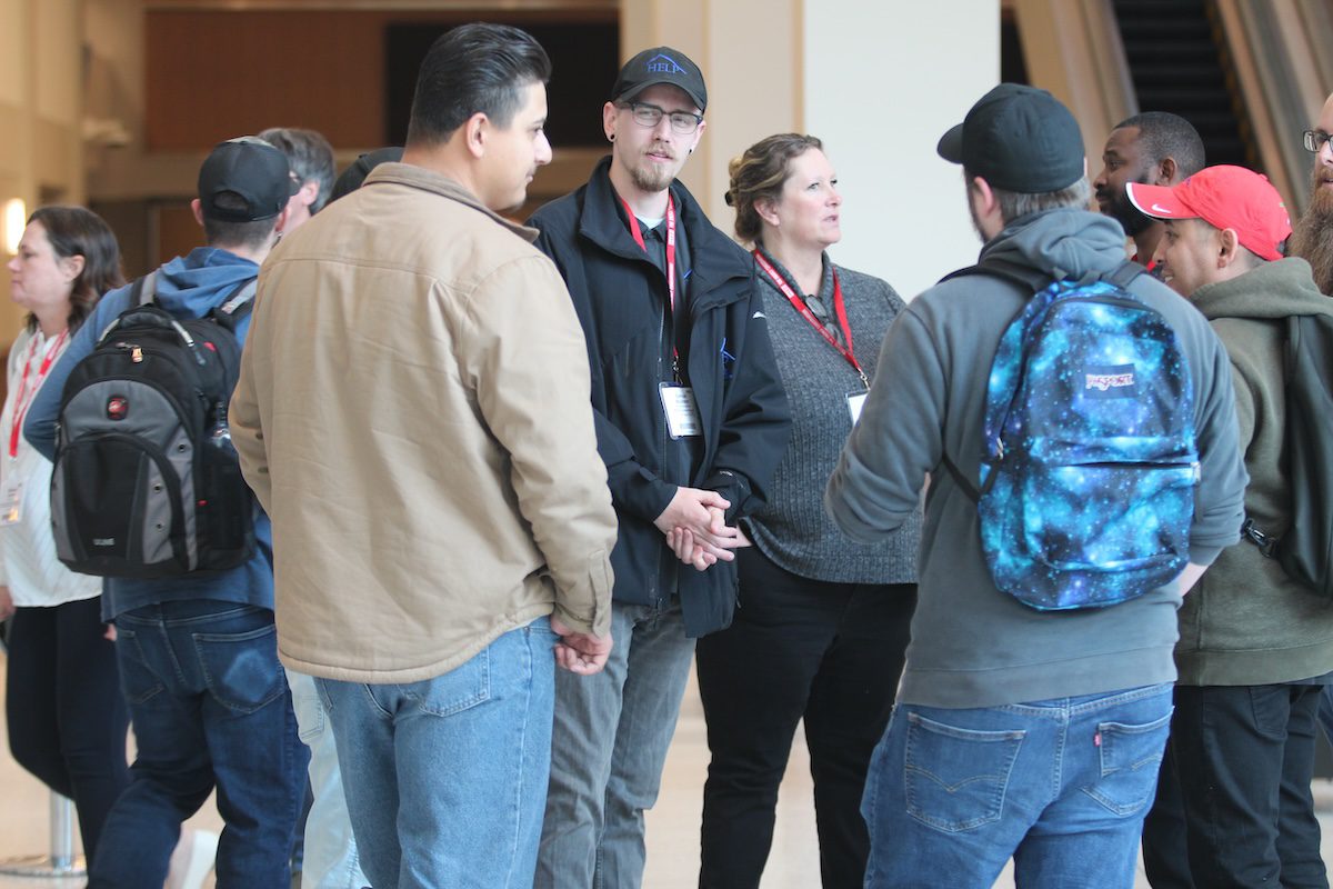 Image of people standing together and talking