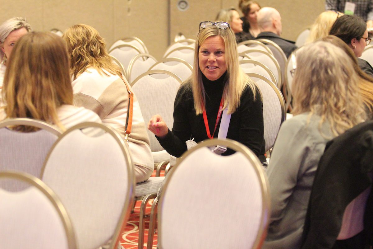 Image of a woman talking to a small group of people