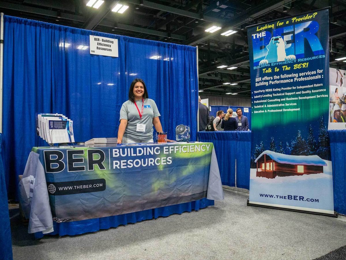 Image of a woman at a booth called BER Building Efficiency Resources