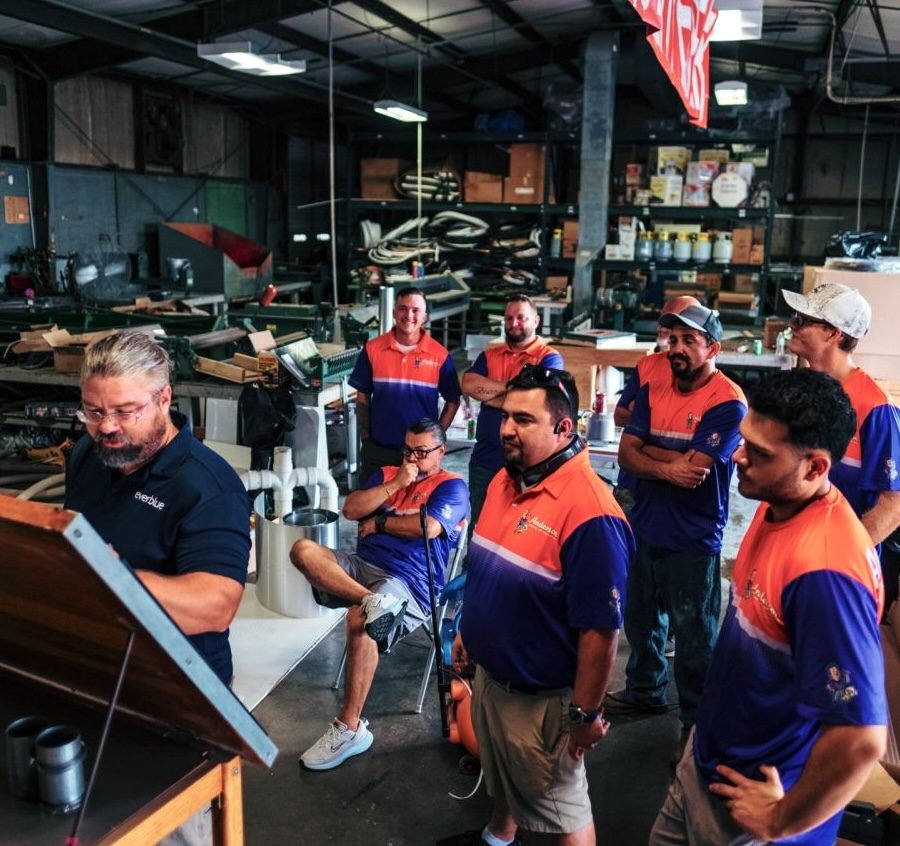 A group of men listening to a trainer