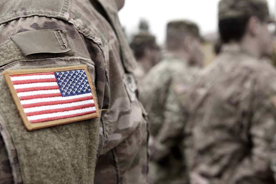 A close of an American flag patch on a military uniform.