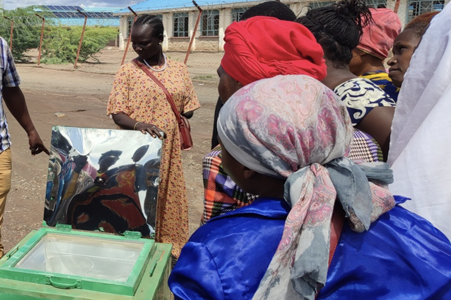 Grace* helped demonstrate solar cooking and trained new project participants. (Credit: Ecomandate Foundation)