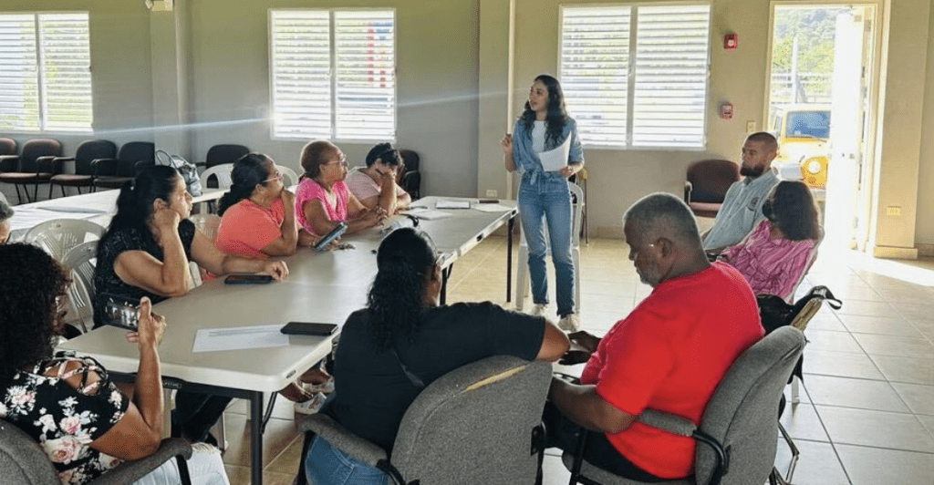 IREC Program Manager Melanie Quiñones (center) in Villa Esperanza, Toa Alta