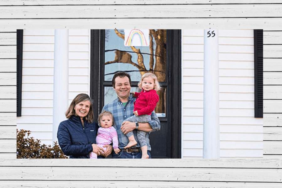 family in front of house